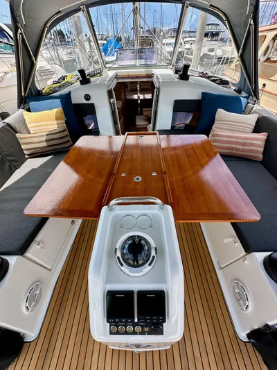 Kemosabe Yacht Photos Pics Jeanneau Sun Odyssey 440 cockpit with wooden table and navigation instruments, 2021 model.