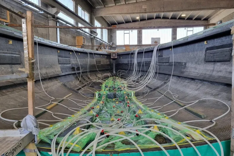  Yacht Photos Pics Interior view of 2026 Ice Yachts ICE 66 Farr under construction, showcasing hull and wiring.