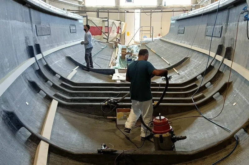  Yacht Photos Pics Workers constructing 2026 Ice Yachts ICE 66 Farr hull in a shipyard.