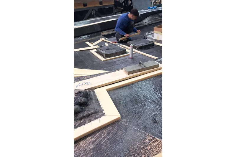  Yacht Photos Pics Worker constructing 2026 Ice Yachts ICE 66 Farr, focusing on yacht deck assembly.