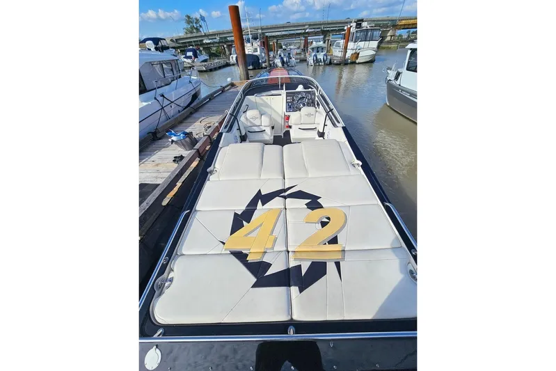 Tiret Yacht Photos Pics 2004 Fountain 42 Lightning boat docked, featuring sleek design and spacious seating.