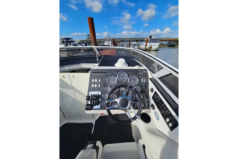Tiret Yacht Photos Pics Cockpit of 2004 Fountain 42 Lightning boat with steering wheel and instrument panel.