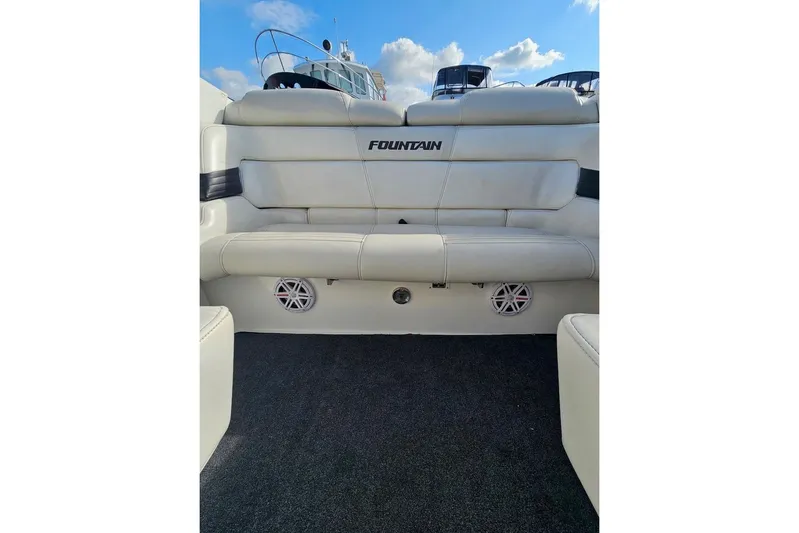 Tiret Yacht Photos Pics 2004 Fountain 42 Lightning boat interior with white seating and speakers.