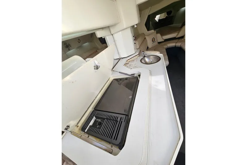 Tiret Yacht Photos Pics Interior of 2004 Fountain 42 Lightning boat with kitchenette and seating area.