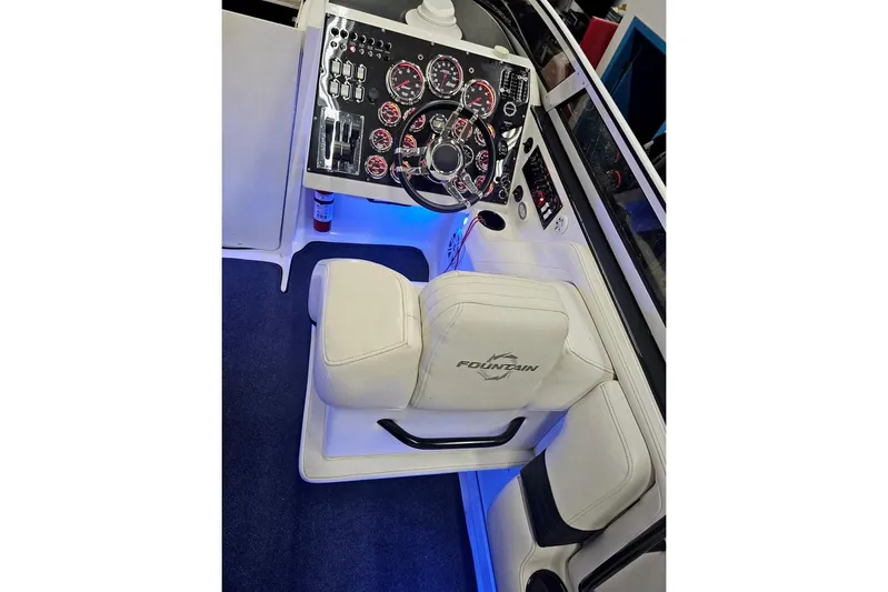 Tiret Yacht Photos Pics Cockpit of 2004 Fountain 42 Lightning boat with illuminated dashboard and steering wheel.