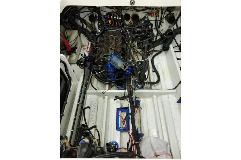 Tiret Yacht Photos Pics Engine compartment of a 2004 Fountain 42 Lightning boat, showcasing wiring and components.