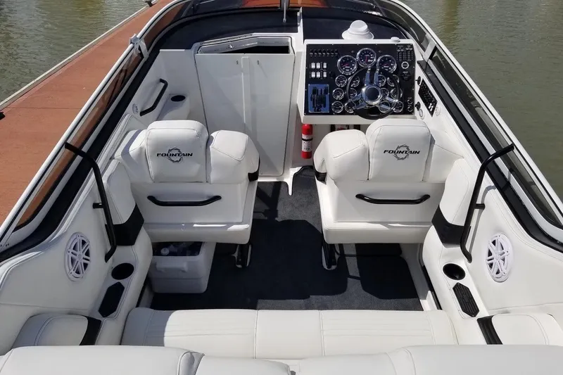 Tiret Yacht Photos Pics 2004 Fountain 42 Lightning boat interior with white seating and detailed dashboard controls.