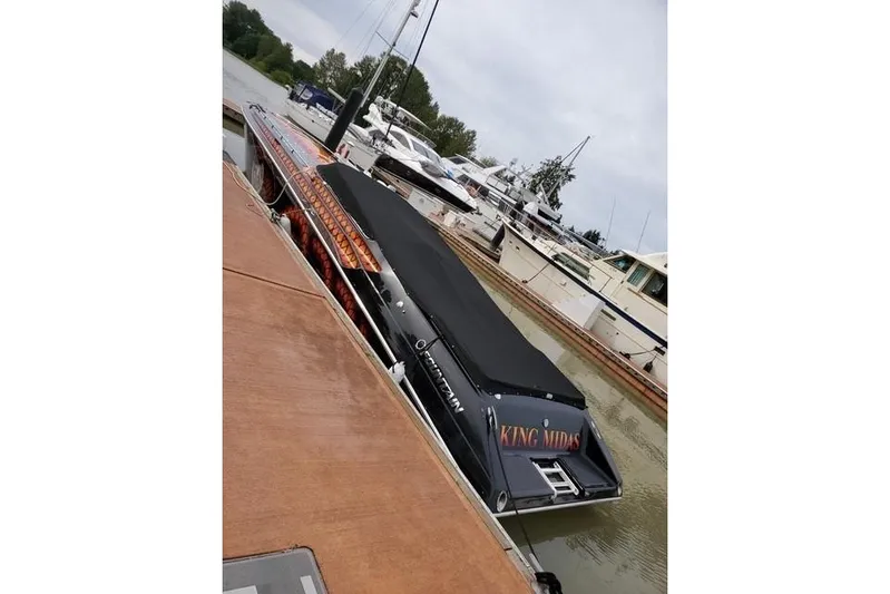 Tiret Yacht Photos Pics 2004 Fountain 42 Lightning speedboat docked, featuring "King Midas" on the stern.