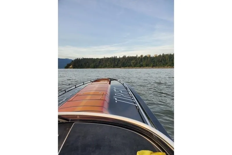 Tiret Yacht Photos Pics 2004 Fountain 42 Lightning boat on water with scenic forested shoreline.