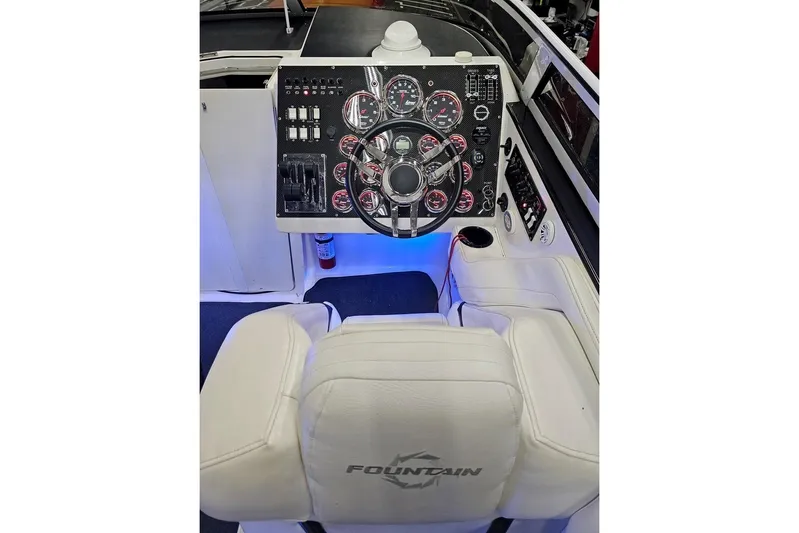 Tiret Yacht Photos Pics Cockpit of 2004 Fountain 42 Lightning boat with illuminated dashboard and steering wheel.
