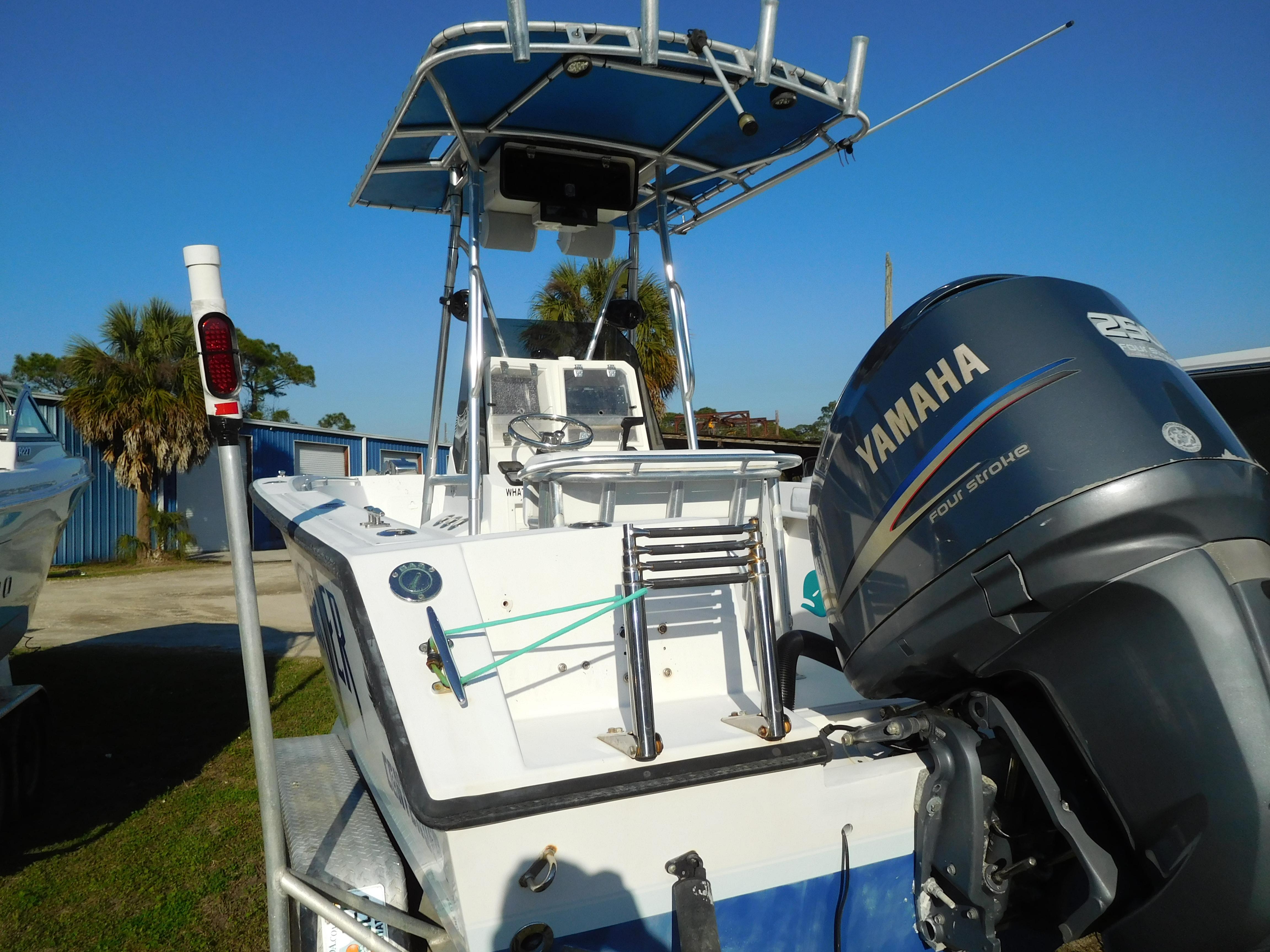 2007 Contender 21 CC boat with Yamaha outboard motor, parked outdoors.