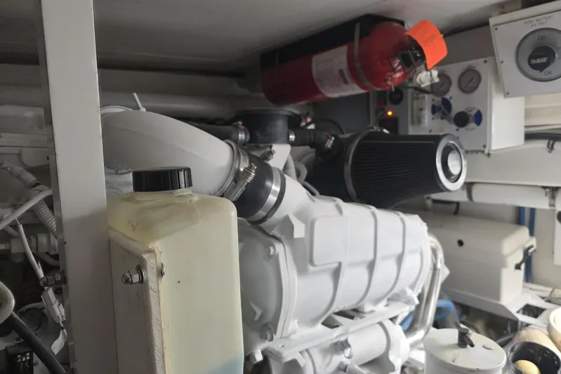 Junior 2 Yacht Photos Pics Engine room of a 2008 Post 42 boat, featuring machinery and a fire extinguisher.