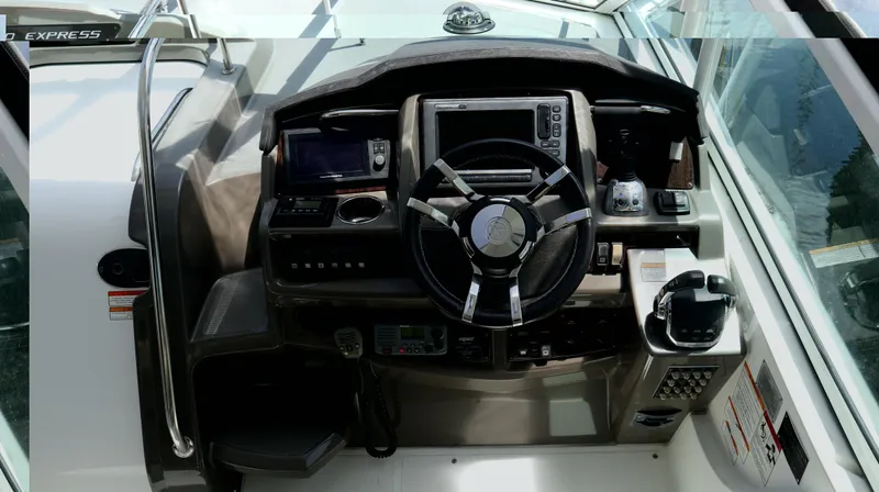 Seas The Day Yacht Photos Pics 2012 Cruisers Yachts 350 Express helm with steering wheel and navigation controls.