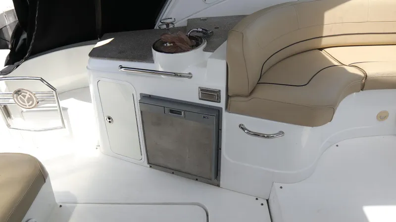 Seas The Day Yacht Photos Pics 2012 Cruisers Yachts 350 Express interior with seating and kitchenette area.