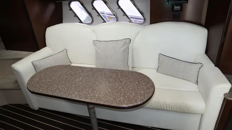 Seas The Day Yacht Photos Pics Luxurious interior of 2012 Cruisers Yachts 350 Express with white sofa and table.