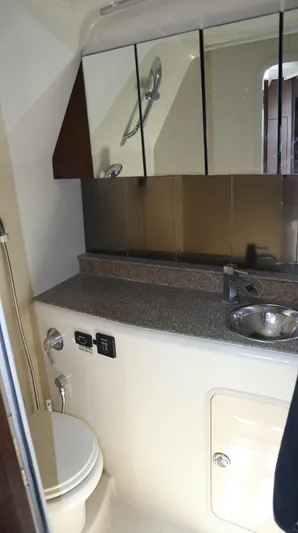Seas The Day Yacht Photos Pics 2012 Cruisers Yachts 350 Express bathroom with sink, mirror, and toilet.