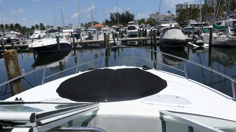 Seas The Day Yacht Photos Pics 2012 Cruisers Yachts 350 Express docked in a marina, surrounded by other boats.