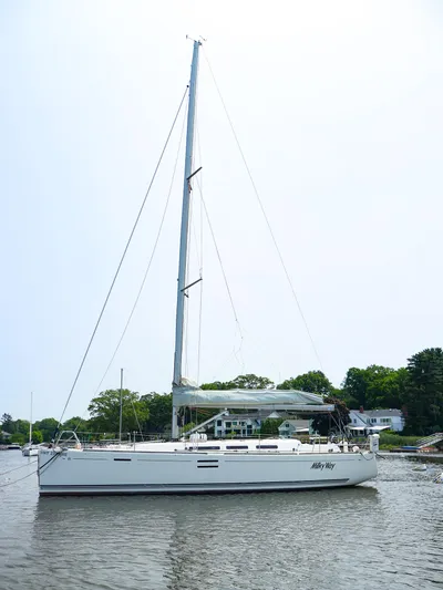  Yacht Photos Pics Sailing yacht Dufour 40E Performance 2011 on calm water, surrounded by greenery.