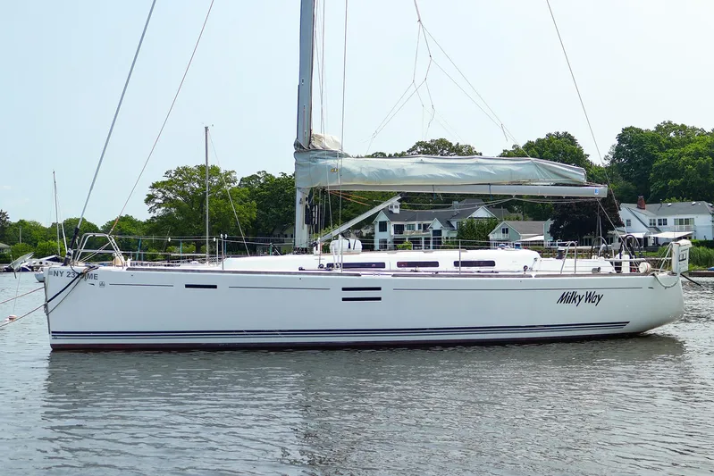  Yacht Photos Pics 2011 Dufour 40E Performance sailboat named "Milky Way" on calm water near houses.
