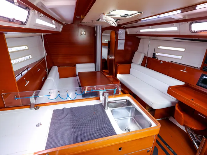  Yacht Photos Pics Interior of 2011 Dufour 40E Performance yacht with wood finish and white seating.