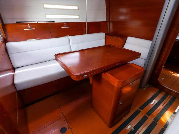  Yacht Photos Pics Interior of 2011 Dufour 40E Performance yacht with wooden table and white seating.