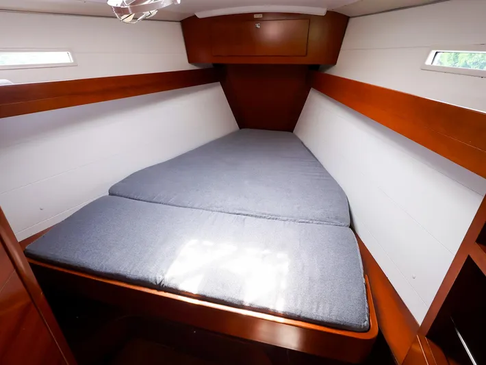  Yacht Photos Pics Cabin interior of 2011 Dufour 40E Performance yacht with cozy bed and wooden finish.