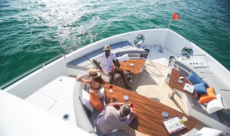  Yacht Photos Pics People relaxing on the deck of a 2022 CL Yachts CLX96, enjoying drinks and ocean views.