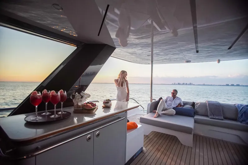  Yacht Photos Pics Luxurious 2022 CL Yachts CLX96 yacht interior with ocean view at sunset.