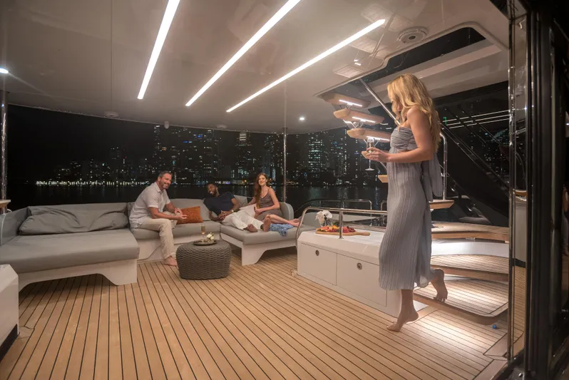  Yacht Photos Pics Luxurious 2022 CL Yachts CLX96 interior with people enjoying a night view.