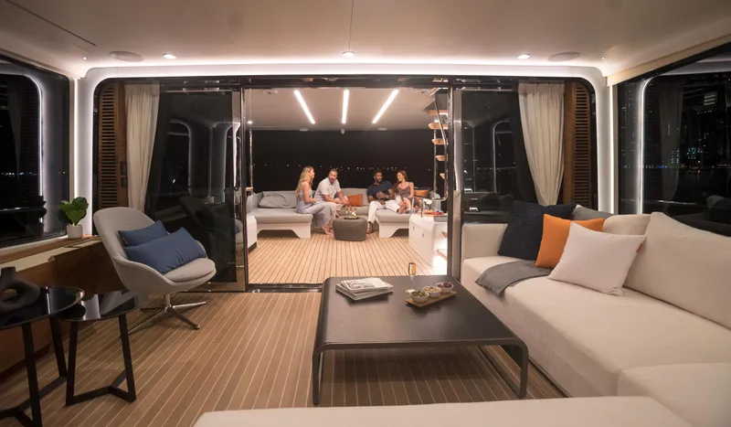  Yacht Photos Pics Luxurious interior of 2022 CL Yachts CLX96 with people relaxing in the lounge area.