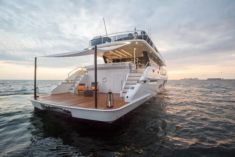  Yacht Photos Pics Luxurious 2022 CL Yachts CLX96 yacht on open water at sunset.