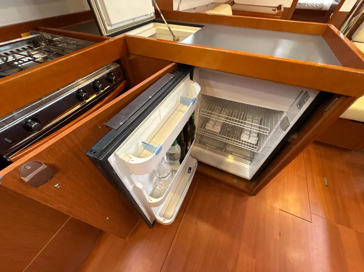 Samba Yacht Photos Pics Interior of 2012 Beneteau Oceanis 48 yacht showing open fridge and stove in galley.