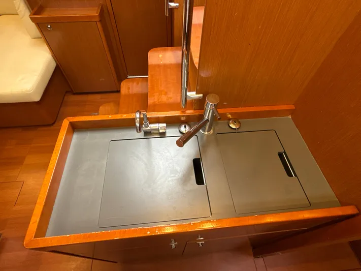 Samba Yacht Photos Pics Interior sink area of 2012 Beneteau Oceanis 48 yacht with wooden cabinetry.