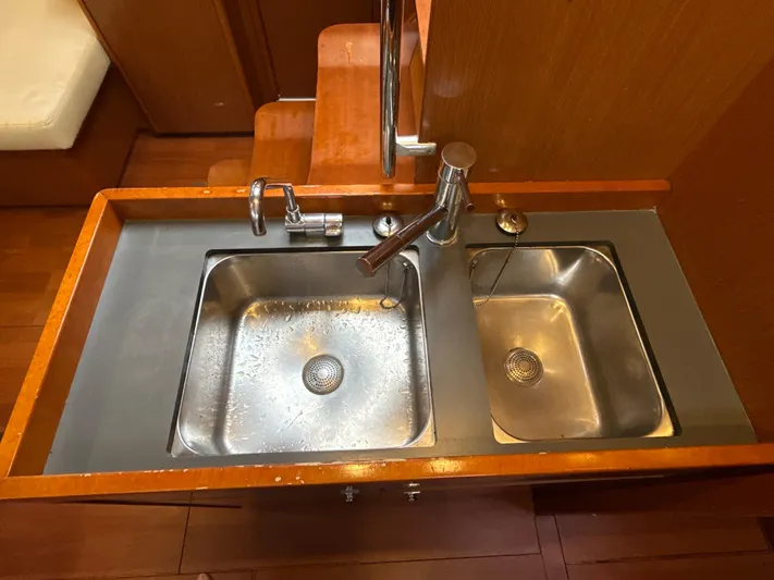 Samba Yacht Photos Pics Galley sink area in 2012 Beneteau Oceanis 48 yacht, featuring dual stainless steel basins.