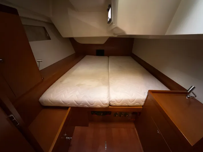 Samba Yacht Photos Pics Cozy cabin interior of 2012 Beneteau Oceanis 48 yacht with double bed and wooden furnishings.