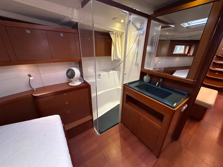 Samba Yacht Photos Pics Interior of 2012 Beneteau Oceanis 48 yacht with wood finish, shower, and sink.