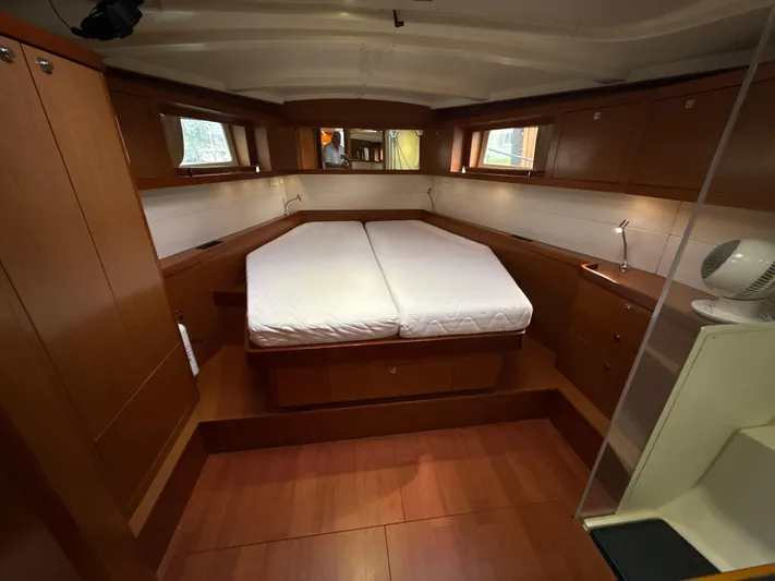 Samba Yacht Photos Pics Interior cabin of 2012 Beneteau Oceanis 48 yacht with double bed and wooden finish.