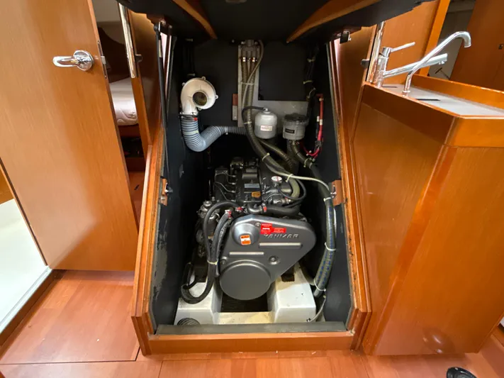 Samba Yacht Photos Pics Engine compartment of a 2012 Beneteau Oceanis 48 sailboat, showcasing the motor and surrounding components.
