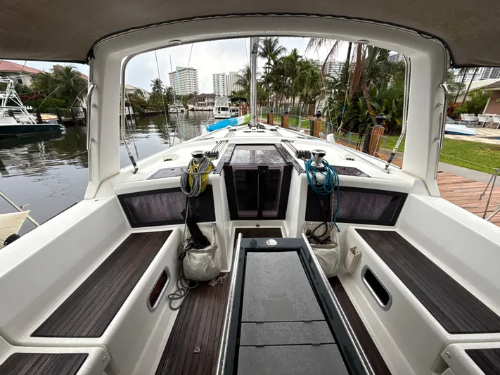 Samba Yacht Photos Pics Beneteau Oceanis 48 sailboat cockpit, 2012 model, docked near palm trees and waterfront buildings.