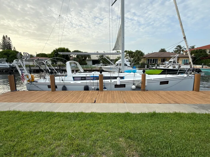 Samba Yacht Photos Pics Beneteau Oceanis 48 sailboat docked by a wooden pier, 2012 model.