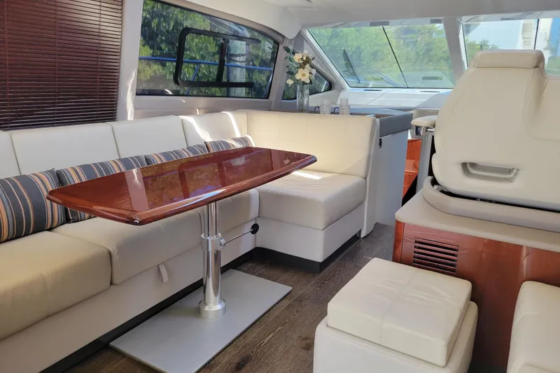  Yacht Photos Pics Luxurious interior of 2017 Sea Ray Sundancer 460 yacht with elegant seating and table.