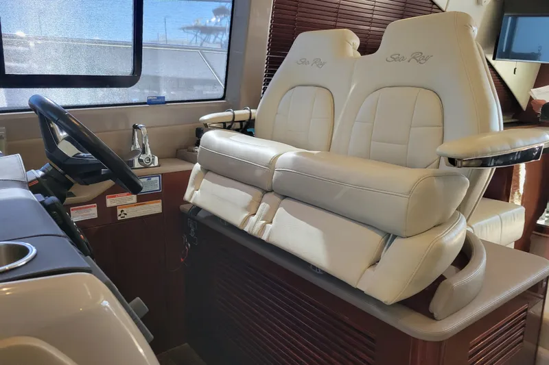  Yacht Photos Pics Interior helm of 2017 Sea Ray Sundancer 460 with plush seating and steering wheel.