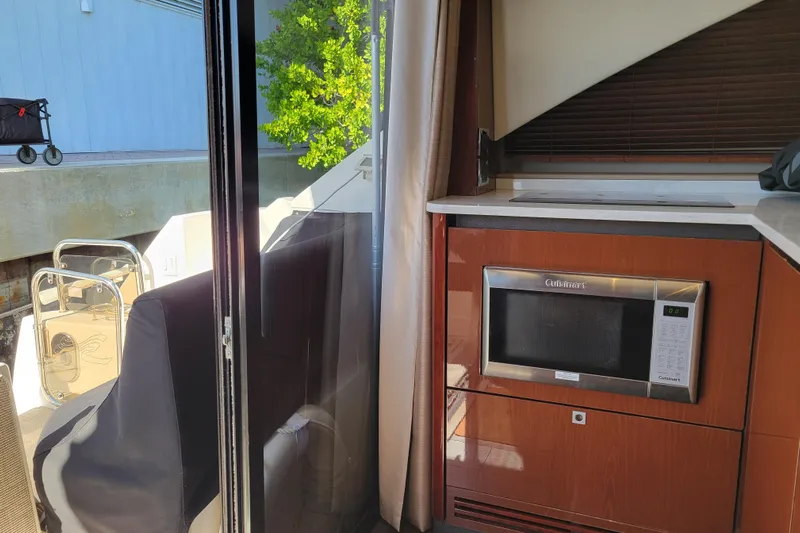  Yacht Photos Pics 2017 Sea Ray Sundancer 460 interior with microwave and outdoor view.