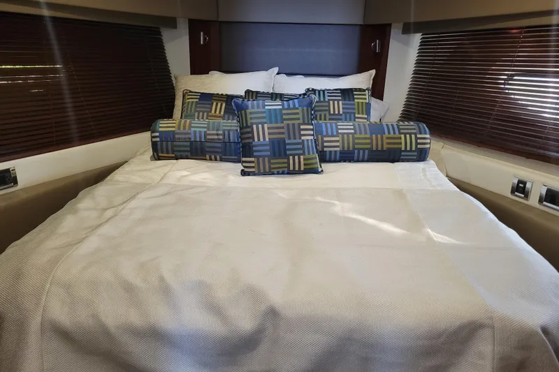  Yacht Photos Pics Luxurious bedroom interior of 2017 Sea Ray Sundancer 460 yacht with patterned cushions.