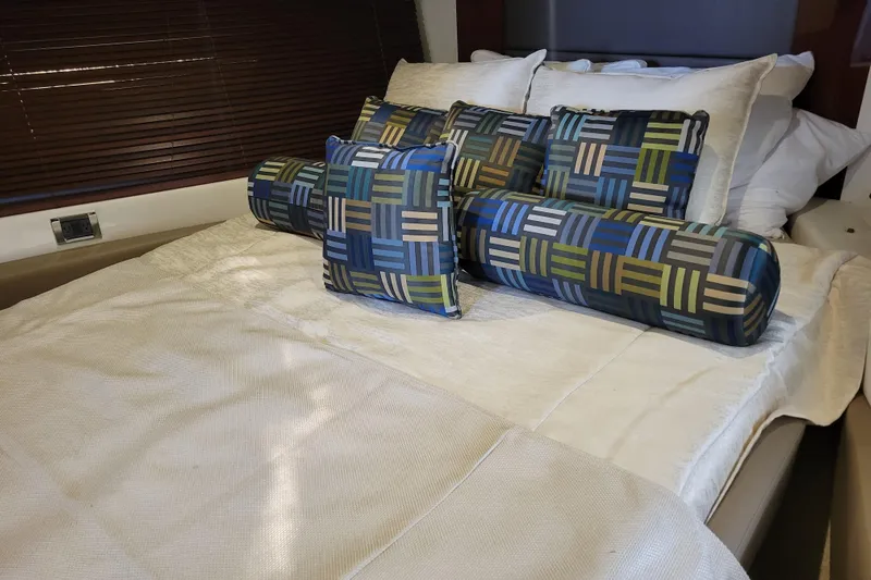  Yacht Photos Pics Luxurious bedroom interior of 2017 Sea Ray Sundancer 460 yacht with patterned cushions.