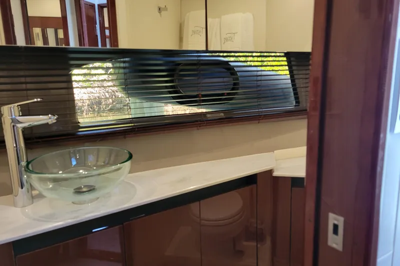  Yacht Photos Pics Luxurious bathroom interior of 2017 Sea Ray Sundancer 460 yacht with glass sink and modern fixtures.