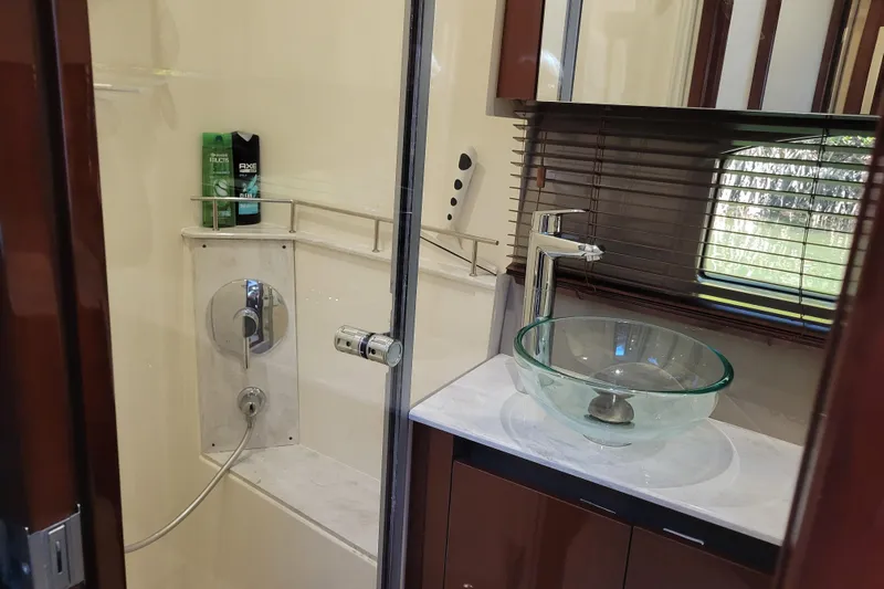  Yacht Photos Pics Luxurious bathroom in 2017 Sea Ray Sundancer 460 yacht with glass sink and modern shower.