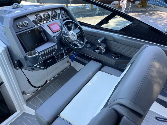  Yacht Photos Pics 2021 Cruisers Yachts 338 CX IO helm with modern controls and luxurious seating.