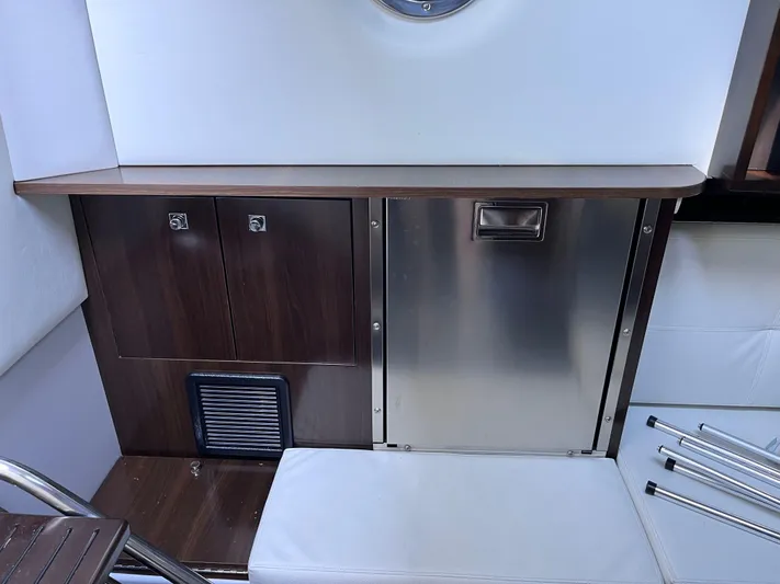  Yacht Photos Pics Interior of 2021 Cruisers Yachts 338 CX IO, featuring sleek cabinetry and stainless steel accents.