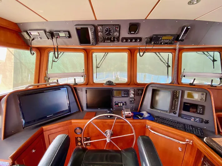 Bunyip I Yacht Photos Pics Nordhavn 47 yacht helm, 2002 model, featuring navigation equipment and steering wheel.